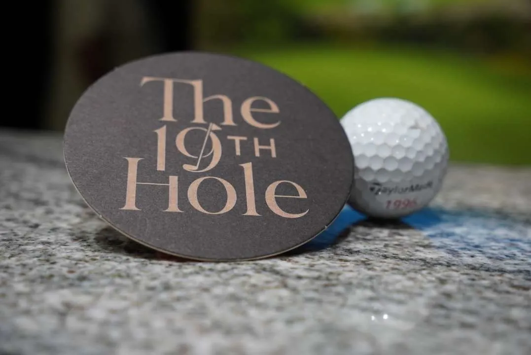 The 19th Hole coaster and golf ball on the bar